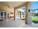 Covered outdoor patio with travertine flooring, a ceiling fan, and plenty of space for seating at 6997 E Paradise Ranch Rd, Paradise Valley, AZ 85253