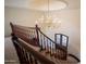 Elegant curved staircase with wooden railing and chandelier, providing a grand entrance at 6997 E Paradise Ranch Rd, Paradise Valley, AZ 85253