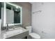 Modern bathroom featuring quartz counters, a designer backsplash, and a backlit mirror at 706 E Washington St # 207, Phoenix, AZ 85034