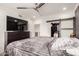 A primary bedroom with a ceiling fan, TV and dresser, plus a sliding barn door to the closet at 706 E Washington St # 207, Phoenix, AZ 85034