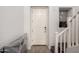 Entryway featuring a white front door, tiled floors, stairs, and decorative niche at 706 E Washington St # 207, Phoenix, AZ 85034