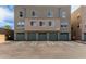 Condo garages with updated olive painted doors and designated parking in front at 706 E Washington St # 207, Phoenix, AZ 85034