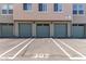Condo garages with updated olive painted doors and designated parking in front at 706 E Washington St # 207, Phoenix, AZ 85034