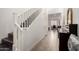 Hallway featuring a staircase and tiled floors leading to a separate office area at 706 E Washington St # 207, Phoenix, AZ 85034