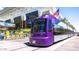 Modern purple light rail car with American flag, Fan Fest signage, and the Phoenix Convention Center visible at 706 E Washington St # 207, Phoenix, AZ 85034