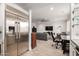 View of the living room from kitchen showing tiled floors, natural lighting and a contemporary design at 706 E Washington St # 207, Phoenix, AZ 85034