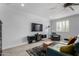 Relaxing living room featuring a plush gray sofa, entertainment center, and natural light at 706 E Washington St # 207, Phoenix, AZ 85034