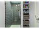 Modern shower with tiled walls, glass door, and built-in shelving at 706 E Washington St # 207, Phoenix, AZ 85034