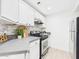 Well-lit kitchen with white cabinetry and stainless steel appliances at 7101 W Beardsley Rd # 621, Glendale, AZ 85308