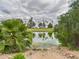 Scenic view of a serene pond surrounded by lush greenery and palm trees at 7101 W Beardsley Rd # 621, Glendale, AZ 85308