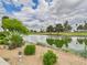 Scenic view of a pond with mature trees in a beautifully landscaped area at 7101 W Beardsley Rd # 621, Glendale, AZ 85308