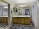 Bathroom with a double sink vanity, tile floors, a large mirror, and sliding shower doors at 7832 E Osage Ave, Mesa, AZ 85212