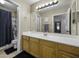 Bathroom featuring a white vanity with a large mirror and a shower-tub combination at 7832 E Osage Ave, Mesa, AZ 85212