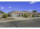 Charming single-story home featuring desert landscaping, tile roof, covered porch, and two-car garage at 7832 E Osage Ave, Mesa, AZ 85212