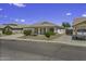 Charming single-story home featuring desert landscaping, tile roof, covered porch, and two-car garage at 7832 E Osage Ave, Mesa, AZ 85212