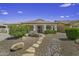 Charming single-story home featuring desert landscaping, tile roof, covered porch, and two-car garage at 7832 E Osage Ave, Mesa, AZ 85212