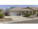 Charming single-story home featuring desert landscaping, tile roof, covered porch, and two-car garage at 7832 E Osage Ave, Mesa, AZ 85212