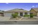 Charming single-story home featuring desert landscaping, tile roof, covered porch, and two-car garage at 7832 E Osage Ave, Mesa, AZ 85212