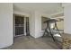 Welcoming covered front porch with a porch swing, security door, and decorative stone accents at 7832 E Osage Ave, Mesa, AZ 85212