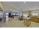 Open concept kitchen and living area with light tile flooring and granite countertops at 7832 E Osage Ave, Mesa, AZ 85212