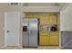 Kitchen featuring stainless steel refrigerator and warm wood cabinetry and granite countertops at 7832 E Osage Ave, Mesa, AZ 85212