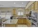 Bright kitchen featuring stainless steel appliances, granite countertops, and warm wood cabinetry at 7832 E Osage Ave, Mesa, AZ 85212