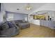 Open-concept living room featuring hardwood floors, ample natural light, and seamless flow into the kitchen at 7832 E Osage Ave, Mesa, AZ 85212