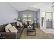 Comfortable living room with a sofa, loveseat, pillows, lamps and a glass table at 7832 E Osage Ave, Mesa, AZ 85212