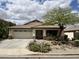 Charming single-story home with a desert landscaped front yard and a two-car garage at 830 E Dry Creek Rd, San Tan Valley, AZ 85143