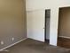 Bedroom with neutral carpet and a closet with sliding doors, providing convenient storage at 830 E Dry Creek Rd, San Tan Valley, AZ 85143
