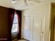 Bedroom with a window, closet and accent wall provides a cozy retreat at 830 E Dry Creek Rd, San Tan Valley, AZ 85143