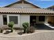 Rear exterior view of home, showing back patio, desert landscaping, and mature plantings at 830 E Dry Creek Rd, San Tan Valley, AZ 85143