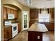 Open kitchen with island and pantry has modern appliances and wood cabinets at 830 E Dry Creek Rd, San Tan Valley, AZ 85143