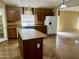 Bright kitchen features an island, plenty of counter space, and modern white appliances at 830 E Dry Creek Rd, San Tan Valley, AZ 85143
