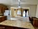 Open concept kitchen flows into the living area, with tile flooring and a view of the backyard at 830 E Dry Creek Rd, San Tan Valley, AZ 85143