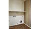 Functional laundry room with tile flooring and practical shelving at 830 E Dry Creek Rd, San Tan Valley, AZ 85143