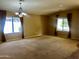 Spacious living room with large windows, neutral walls, and carpet flooring offers ample natural light at 830 E Dry Creek Rd, San Tan Valley, AZ 85143