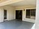 Covered patio space with door to interior, window to backyard and painted concrete floor at 830 E Dry Creek Rd, San Tan Valley, AZ 85143