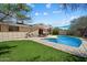 Refreshing backyard featuring a pool, patio with a pergola, and lush green lawn perfect for outdoor enjoyment at 8725 E Coronado Rd, Scottsdale, AZ 85257