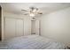 This carpeted bedroom provides a ceiling fan and closet with sliding doors at 8725 E Coronado Rd, Scottsdale, AZ 85257