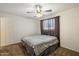 This carpeted bedroom features a ceiling fan and window with curtains at 8725 E Coronado Rd, Scottsdale, AZ 85257
