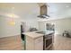 Gourmet kitchen with island seating, stainless steel appliances, and easy access to pool at 8725 E Coronado Rd, Scottsdale, AZ 85257