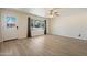 Bright living room featuring new flooring, a ceiling fan, and natural light at 8725 E Coronado Rd, Scottsdale, AZ 85257