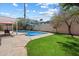 Enjoy this backyard swimming pool with grassy area and outdoor seating space at 8725 E Coronado Rd, Scottsdale, AZ 85257