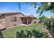 Backyard featuring a lush lawn, covered patio, and privacy fencing, ideal for relaxation at 8745 W Windsor Dr, Peoria, AZ 85381