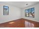 Bright bedroom with hardwood floors and dual windows providing ample natural light at 8745 W Windsor Dr, Peoria, AZ 85381