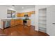 Well-lit kitchen featuring stainless steel appliances, wood cabinets, and an adjacent pantry at 8745 W Windsor Dr, Peoria, AZ 85381