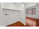 Laundry room with hardwood floors, shelving and window that overlooks a palm tree at 8745 W Windsor Dr, Peoria, AZ 85381