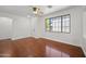 Well-lit living room showcases wood floors, a large window, and a ceiling fan at 8745 W Windsor Dr, Peoria, AZ 85381