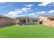 A well-maintained backyard features artificial grass and an inviting patio area for outdoor enjoyment at 9343 W Atlantis Way, Tolleson, AZ 85353
